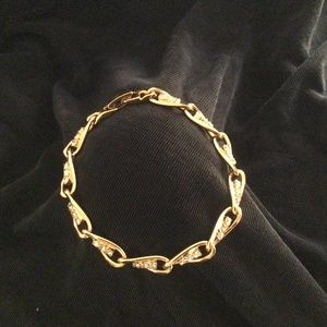 Highly polished delicate goldtone & rhinestone bracelet. 7”